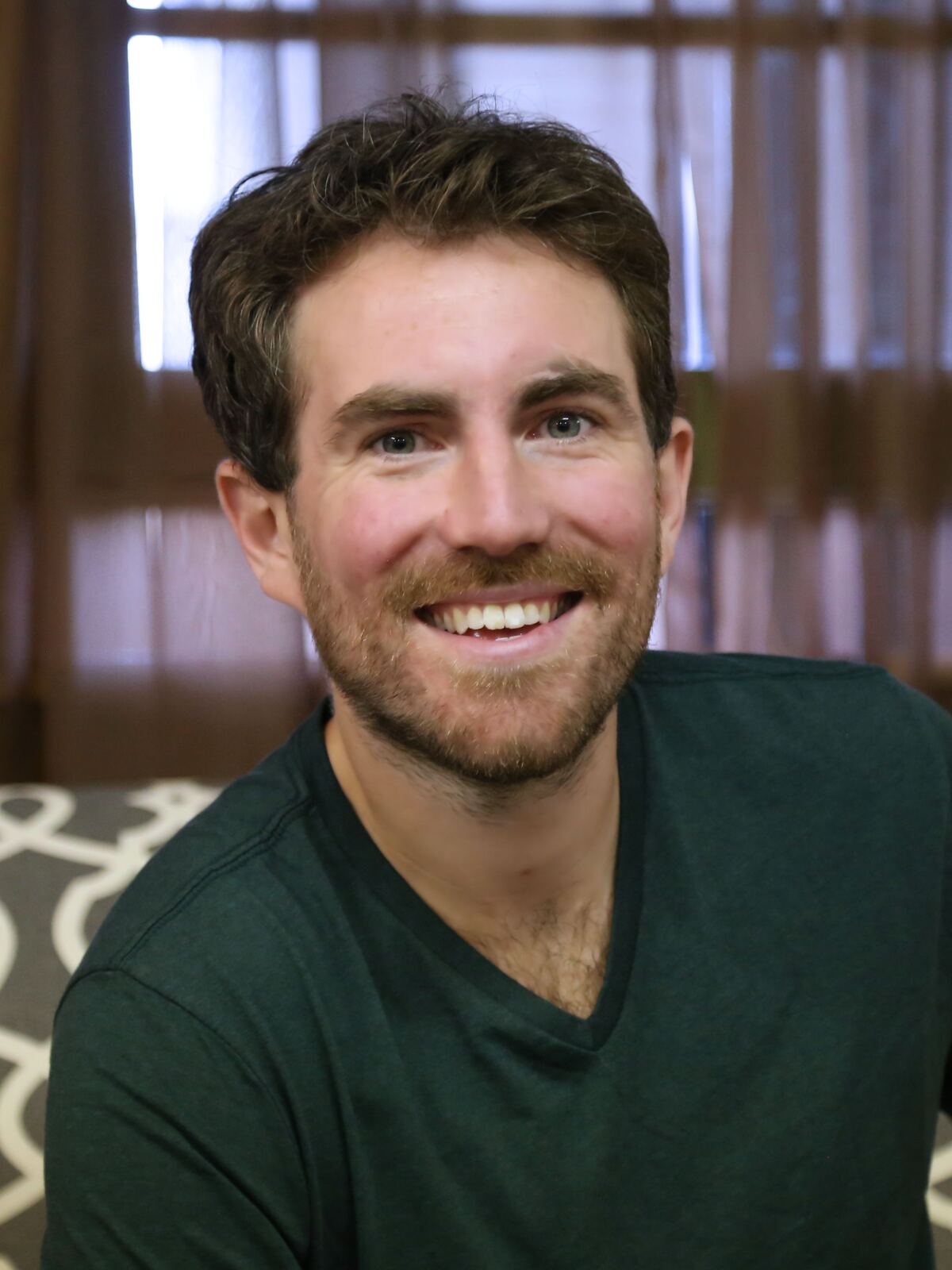 Jeremy Kauffman, smiling, in a dark green shirt.